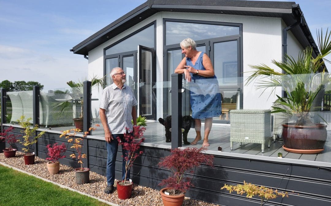 residents of a park home on their balcony and in their garden