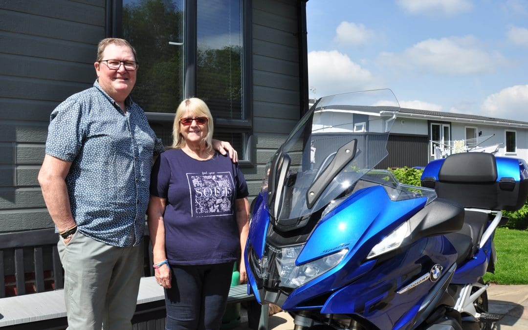 Older couple with motorbike getting the work-life balance right